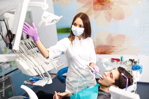 Overview of dental caries prevention.man at the dentist s chair during a dental procedure. Beautiful man smile close up. Healthy Smile. Beautiful male Smile  