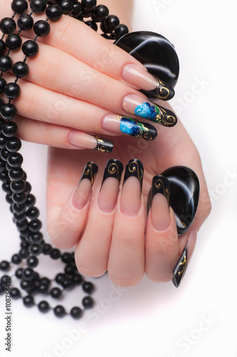 Closeup photo of a beautiful female hands with nail design in the Russian style. Isolated on white background