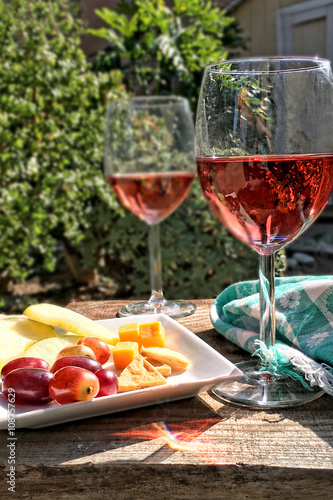 Two glasses with rose wine on a patio table