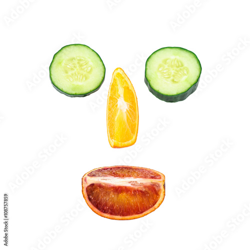 Face lined with orange  and cucumber slices
