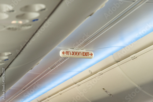 Emergency Exit Row in Airplane; Exit sign in Thai Language.