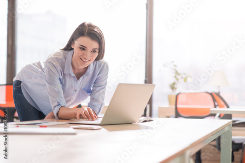 Positive girl working in the office     
