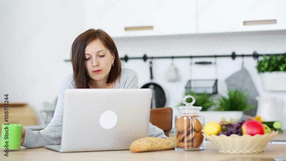 Working on laptop at the kitchen Working on laptop at the kitchen