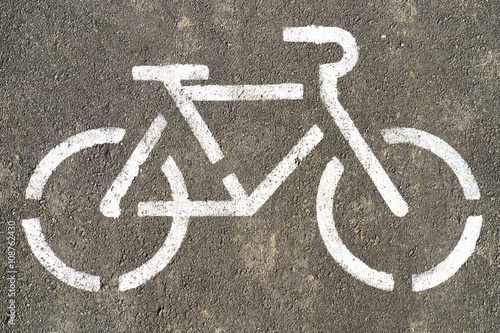 Bicycle symbol on textured asphalt background