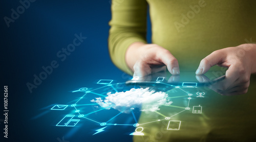 Close up of hand holding tablet with cloud network technology