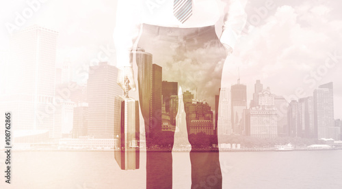 Businessman standing at cityscape background
