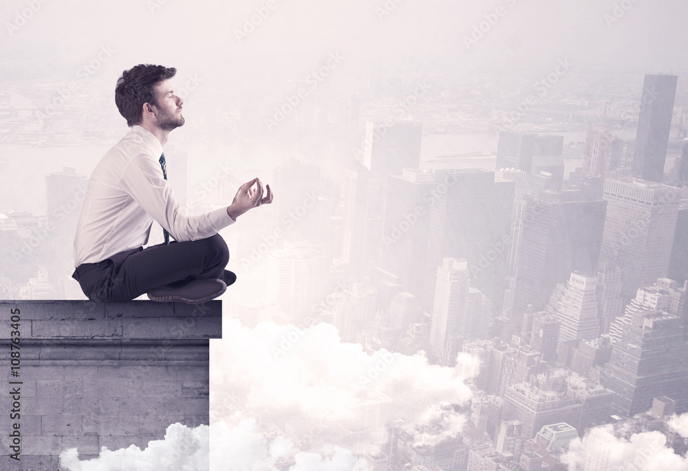 Sales person sitting on building edge in city Sales person sitting on building edge in city