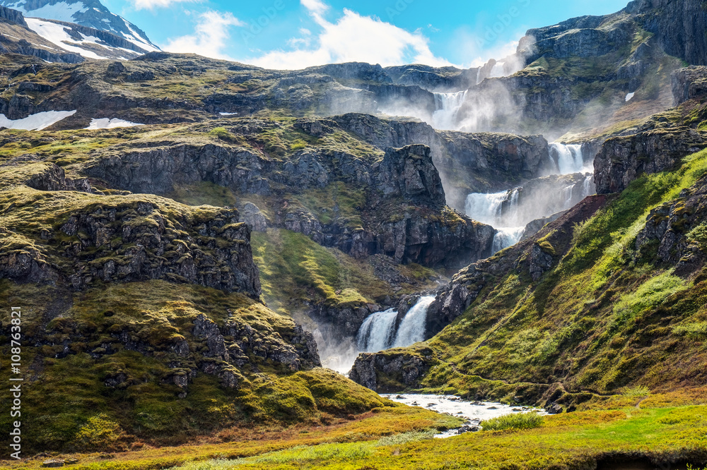 Fototapeta premium The Klifbrekkufossar waterfall in the Mjoifjordur fjord in Iceland