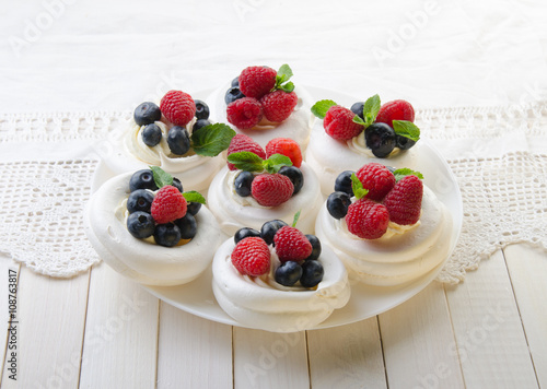 Homemade pavlova meringue cake with fresh berries and whipped cream. Morning. Dessert.