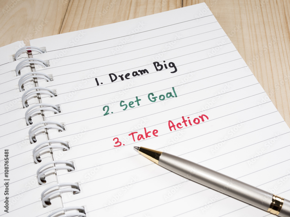 Dream Big, Set Goal , Take Action, handwriting on notebook with wood background Dream Big, Set Goal , Take Action, handwriting on notebook with wood background