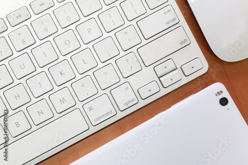 overhead of office table with gadget, computer keyboard and mouse