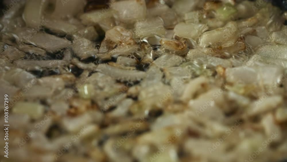 Frying sliced onions in a pan closeup Frying sliced onions in a pan closeup