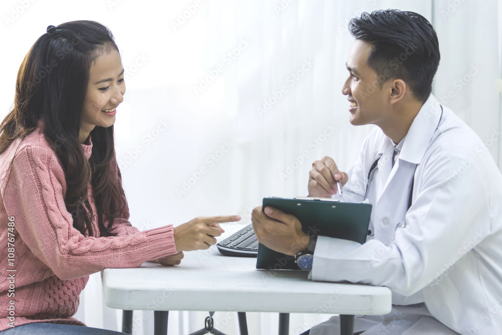 Male Doctor explain something to the patient in a clinic Male Doctor explain something to the patient in a clinic