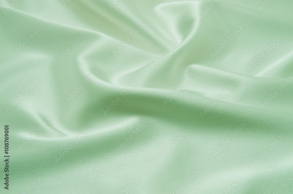 Obraz premium Green satin fabric as background