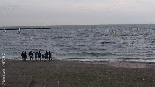 Hi-school girls waching windsurfing in Inage Beachfront Park photo