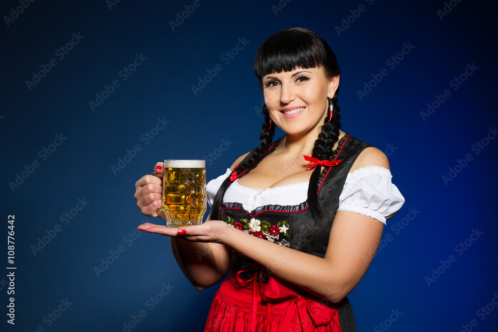 Beautiful brunette woman in Bavarian dressed with glass of beer Beautiful brunette woman in Bavarian dressed with glass of beer