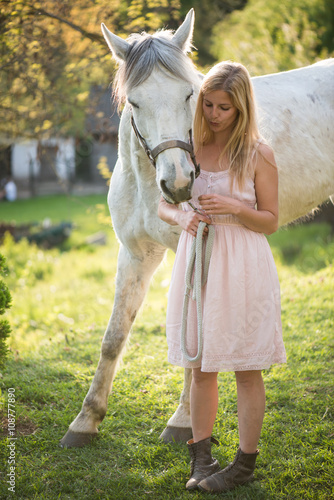 Young blonde woman posing outdoor with white horse.  © Laszlo