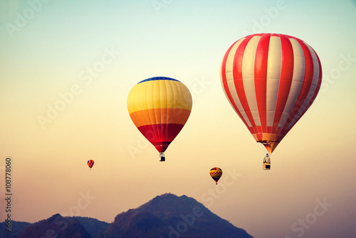 Hot air balloon over mountain on sky sunset , vintage and retro filter effect style © jakkapan