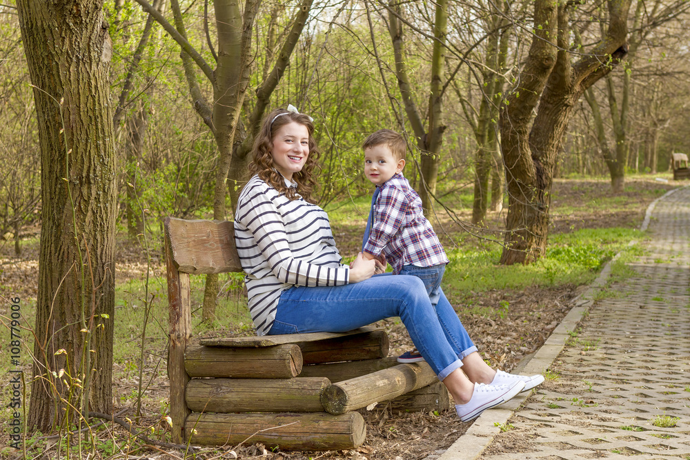 Beautiful pregnant woman outdoor with her little boy Beautiful pregnant woman outdoor with her little boy