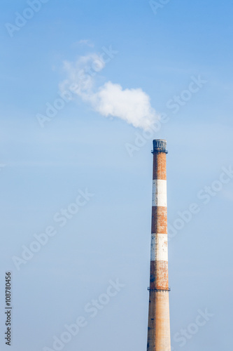 Industrial power plant smoke pollution in the blue sky