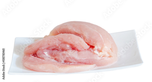 Chicken raw meat on a white plate, close up, white background