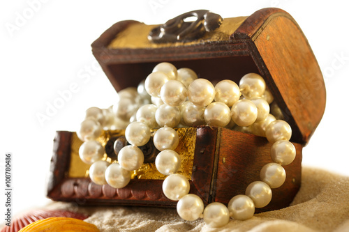 Treasure chest with seashells and pearl