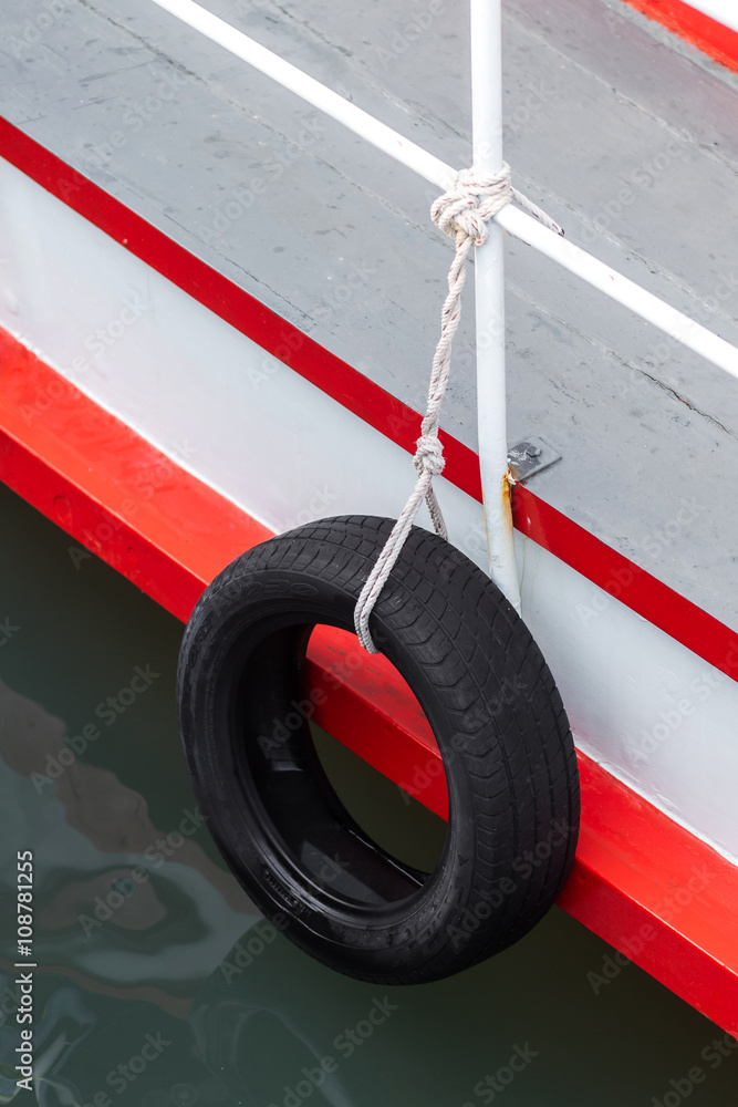 Fototapeta premium Tires used on pier or warf to protect commercial boats when tied