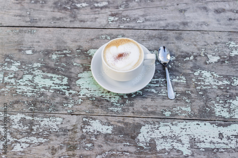 Aroma cappuchino in white cup on old whitetable Aroma cappuchino in white cup on old whitetable