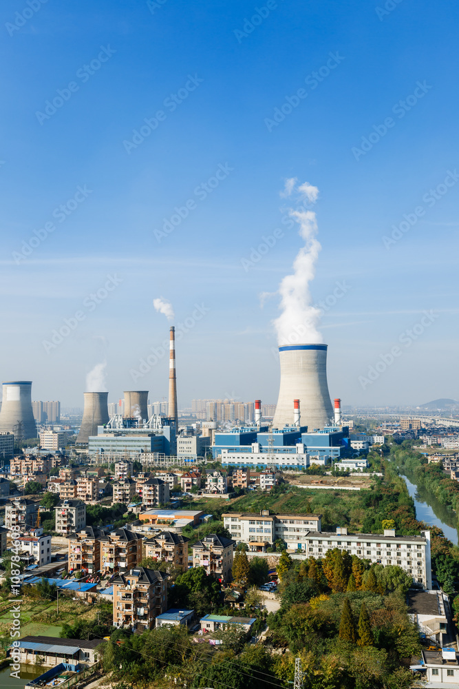 Industrial power plant smoke pollution in urban suburb