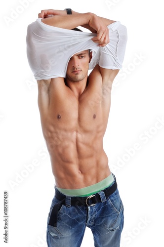 Obraz na plátně Portrait of Powerful Muscular Man Posing on a White Background