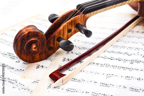 Close view of violin scroll and bow