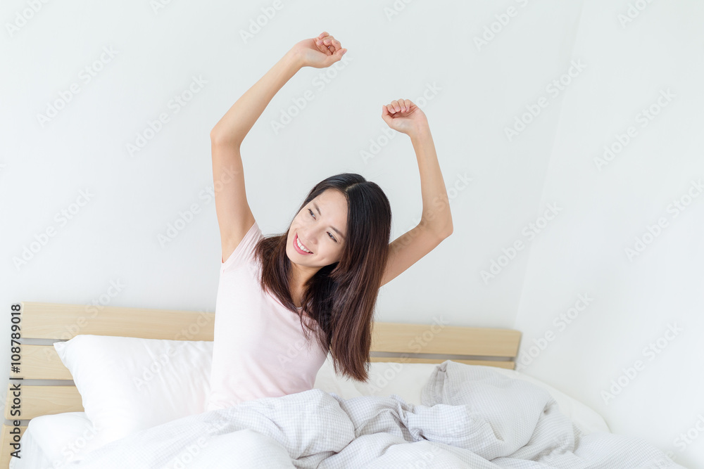 Woman stretching in the morning and smiling Woman stretching in the morning and smiling