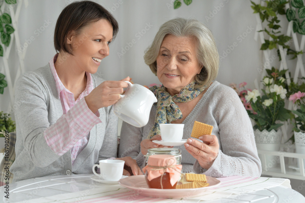 Senior woman with daughter  with tea