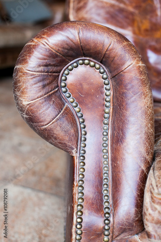 Closeup texture of vintage brown leather armchair in library
