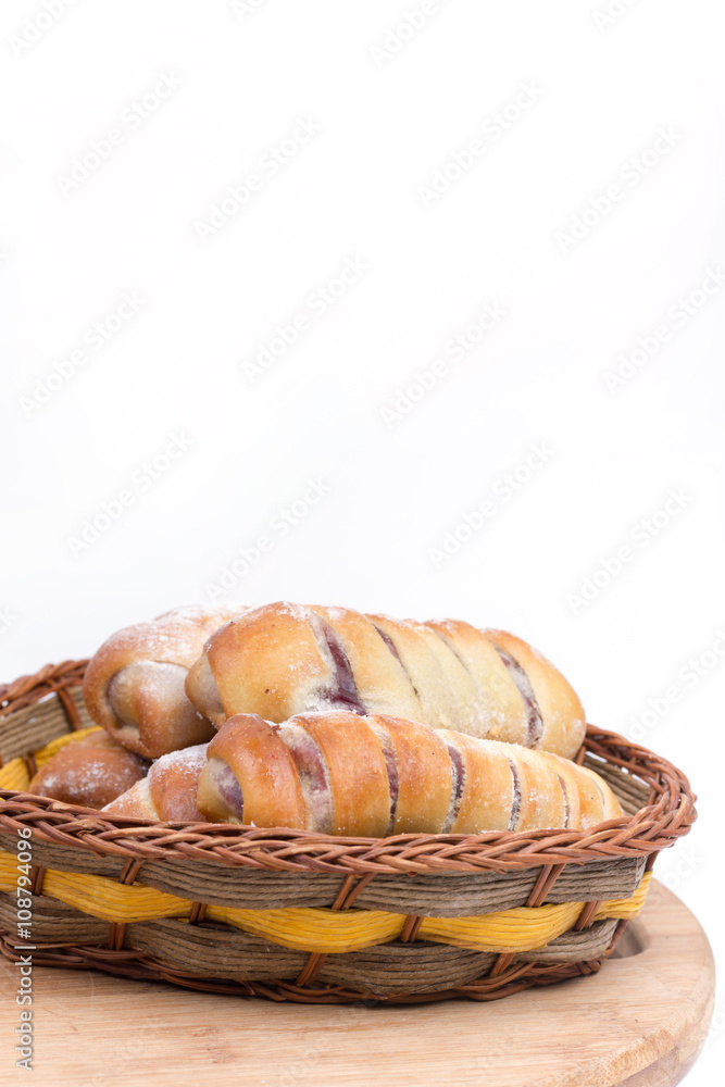 Homemade sweet baked rolls in the wooden basket