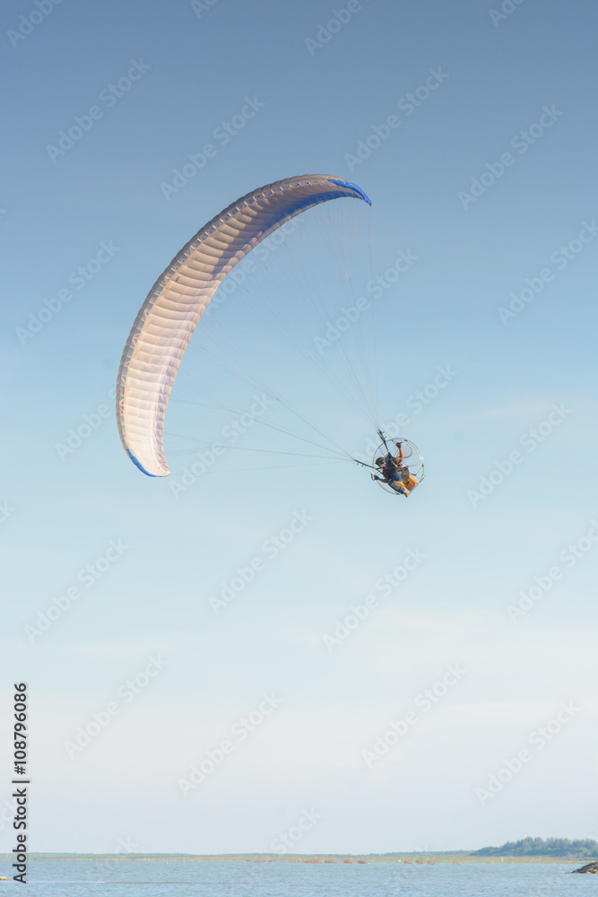 Paramotor on the sky in the evening:Close up,select focus with s