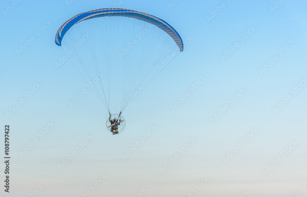 Paramotor on the sky in the evening:Close up,select focus with s Paramotor on the sky in the evening:Close up,select focus with s