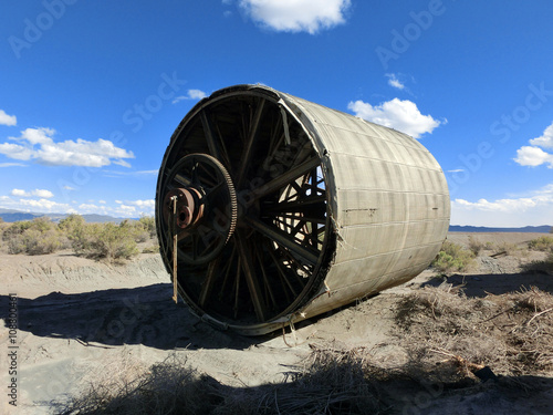 Vintage old heavy equipment round barrel in desert sun - landscape color photo photo