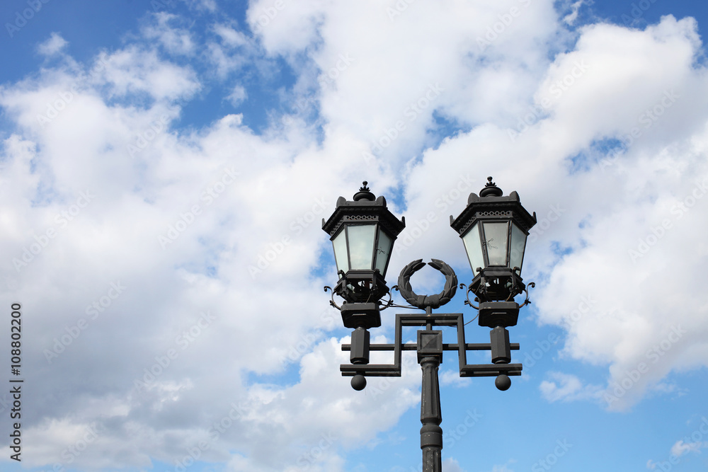 Decorative lamppost, blue sky on background