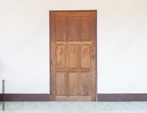 Old wood door on white wall.