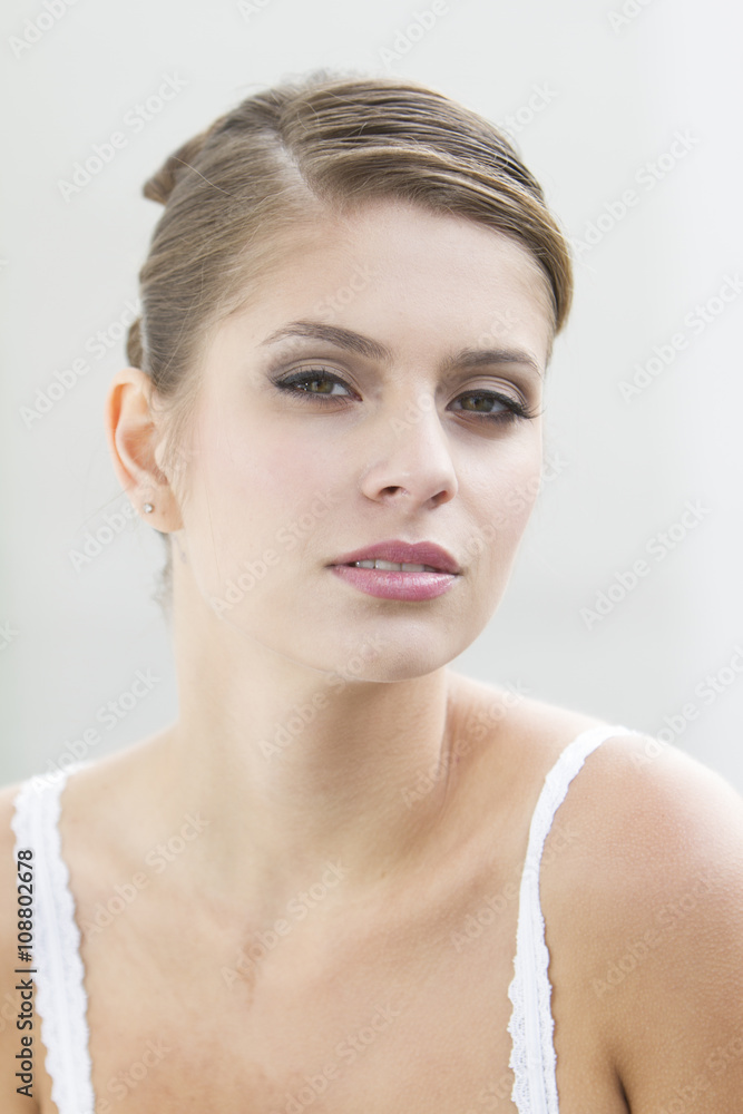 Portrait of a beautiful young woman with collected brown hair Portrait of a beautiful young woman with collected brown hair