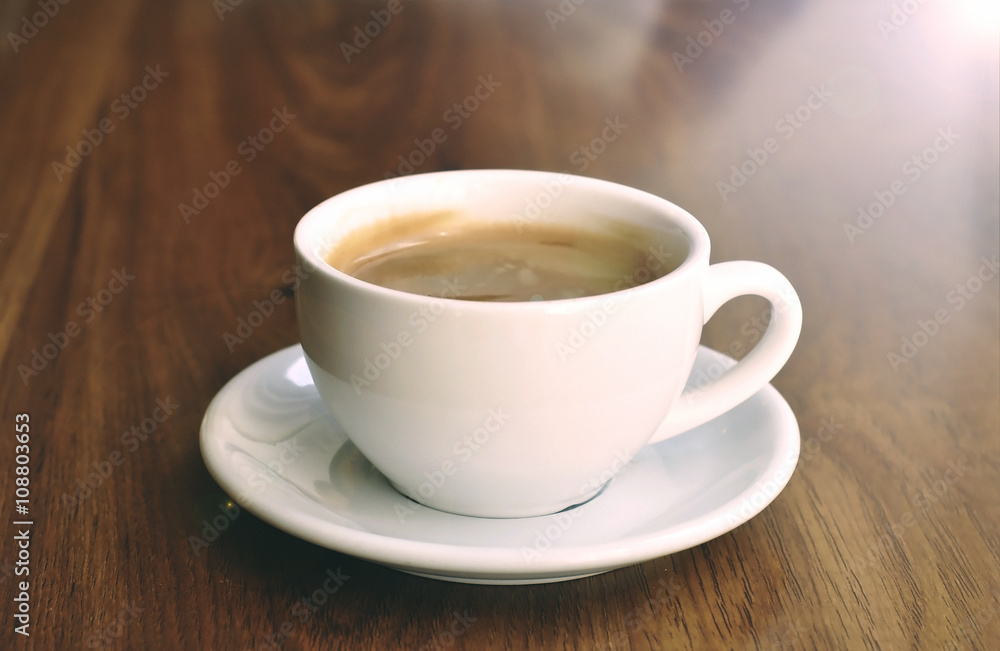 White cup on the wooden table White cup on the wooden table