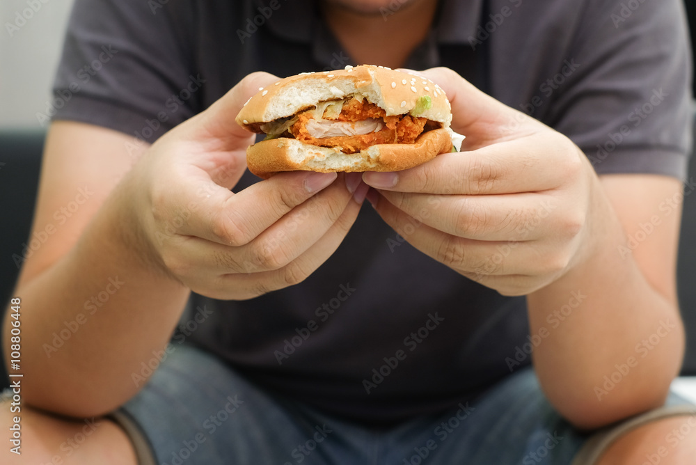 close up man hand gesture showing hamburger:fast food concept. close up man hand gesture showing hamburger:fast food concept.