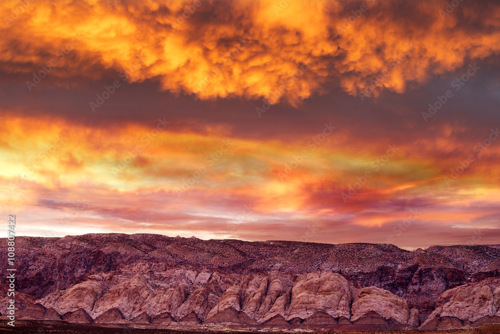 stunning sunset in cloudy sky on mountain range in Utah