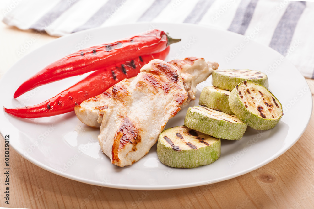 grilled chicken with vegetables on wooden table grilled chicken with vegetables on wooden table