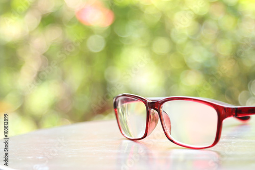 hipster glasses on wooden table with nature background