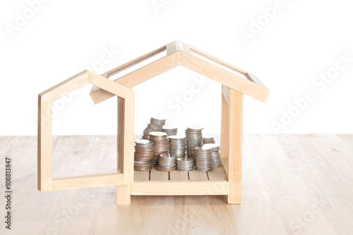 Real estate concept. House with coins stack