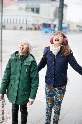 Cute 10  years old girls with umbrellas