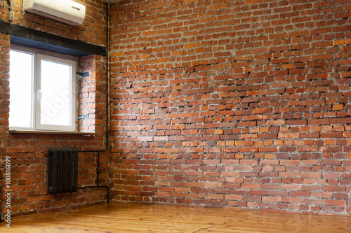  Room with a window  red brick walls and wooden flooring of boar