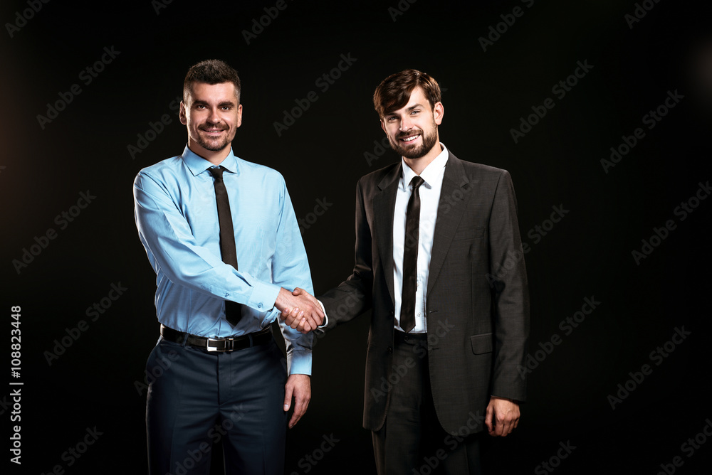 Handsome businessmen on black background Handsome businessmen on black background